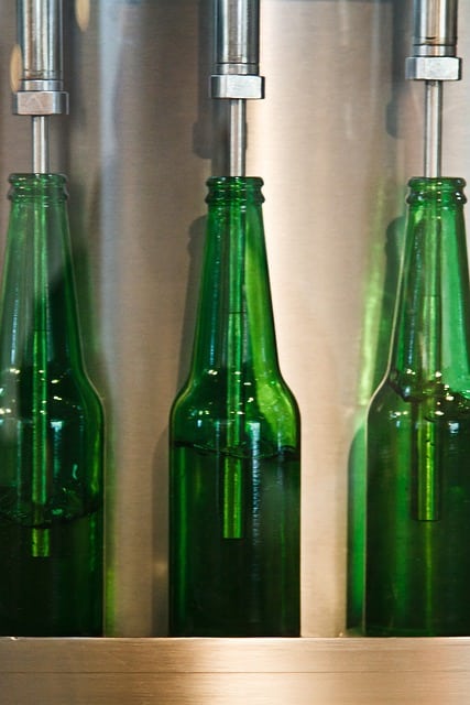 How can a CMMS assist in managing maintenance for bottling plants in the beverage industry?