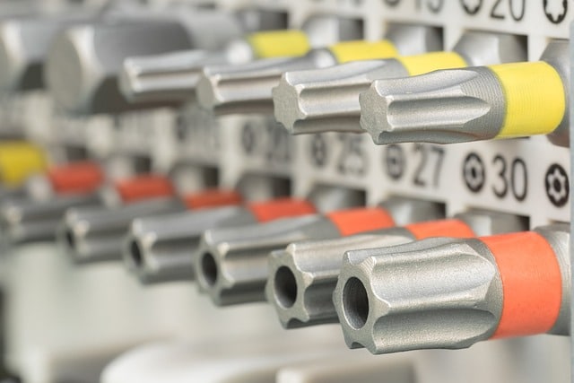 How does a CMMS help manage spare parts inventory in manufacturing?