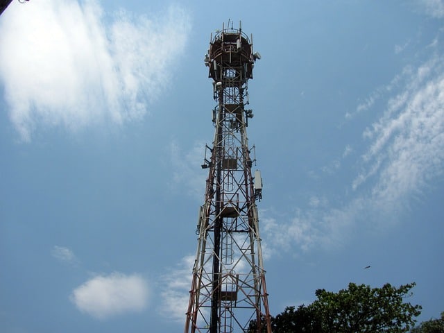 What role does a CMMS play in asset management for telecommunications?